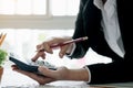 Close up of businessman or accountant hand holding pen working on calculator to calculate business data, accountancy document and Royalty Free Stock Photo