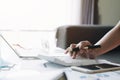 Close up of businessman or accountant hand holding pen working on calculator to calculate business data, accountancy document and Royalty Free Stock Photo