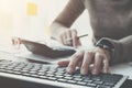 Close up of businessman or accountant hand holding pencil working on calculator to calculate financial data report, accountancy