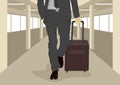 Close up of businessman carrying suitcase while walking at international airport