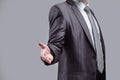 Close up. the businessman extends his hand for greeting .isolated on grey background Royalty Free Stock Photo