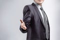 Close up. the businessman extends his hand for greeting .isolated on grey background Royalty Free Stock Photo