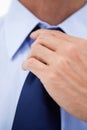 Close up of a businessman fixing his tie Royalty Free Stock Photo