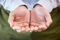 Close up of a businessman in formal clothing holding something imaginary on palms of his hands. Unknown man making a