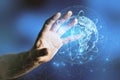 Close up of businessman hand holding abstract glowing globe hologram on blurry blue background. Digital network, data and science Royalty Free Stock Photo