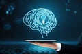 Close up of businessman hand holding cellphone with digital light bulb with human brain inside glowing on blurry blue background. Royalty Free Stock Photo