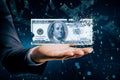 Close up of businessman hand holding digital dollar bill on blurry tech background with binary coding. Business and finance Royalty Free Stock Photo