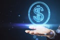 Close up of businessman hand holding glowing round dollar sign on blurry blue bokeh background. Online banking, money and invest Royalty Free Stock Photo