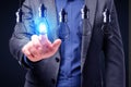 Close up of businessman hand pointing at abstract glowing row of light bulbs on dark background. Idea, solution and innovation Royalty Free Stock Photo