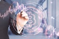 Close up of businessman hand pointing at downward red bitcoin candlestick chart on blurry office interior background. Financial