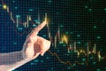 Close up of businessman hand pointing at glowing and growing business chart on blurry grid background. Financial growth, Royalty Free Stock Photo