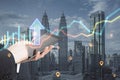 Close up of businessman hand pointing at tablet with abstract glowing growth chart and arrow on blurry city background with Royalty Free Stock Photo