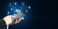Close up of businessman hand pointing at tablet with glowing api data hologram