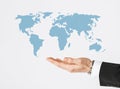 Close up of businessman hand showing world map