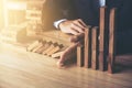 Close up of businessman hand Stopping Falling wooden Dominoes effect from continuous toppled or risk, strategy and successful int Royalty Free Stock Photo