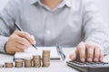 Close up businessman hand using calculator and writing in a notebook Royalty Free Stock Photo