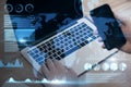 Close up of businessman hand using laptop keyboard and smartphone with abstract map and business chart hologram on blurry Royalty Free Stock Photo