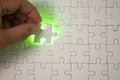 Close up of businessman hands connecting puzzle element and making jigsaw complete. Puzzle jigsaw with green light. Royalty Free Stock Photo