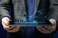 Close up of businessman hands holding tablet with abstract business chart hologram on blurry background. Dashboard, investor and Royalty Free Stock Photo