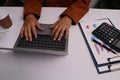 close up Businessman hands searching for data on Notebook with analyzing charts at his workplace Royalty Free Stock Photo