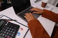 close up Businessman hands searching for data on Notebook with analyzing charts at his workplace Royalty Free Stock Photo