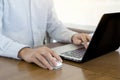 Close up, Businessman hands using mouse and computer laptop, browsing internet information and searching web, working outside Royalty Free Stock Photo