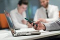 Close up of businessman hands using smart phone on meeting Royalty Free Stock Photo