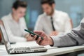 Close up of businessman hands using smart phone on meeting Royalty Free Stock Photo