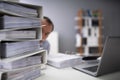 Businessman Hiding Behind The Folders Stack