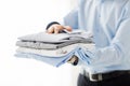 Close up of businessman holding folded shirts