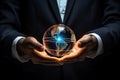 Close up of businessman holding in hands glowing earth globe.