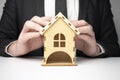 Close-up of businessman holding house model in hands. Mortgage, loan, rent, real estate purchase Royalty Free Stock Photo