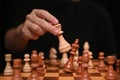 Businessman moving chess figure in competition success play. Business strategy and management concept.