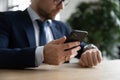 Close up of businessman multitask with gadgets at workplace