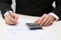 Close up of businessman with papers and calculator