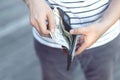 Close up Businessman plaid shirt holding a wallet in the hands of an man take money out of pocket. expenses finance concept. Royalty Free Stock Photo