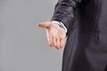 Close up. the businessman reaches out to the partner .isolated on grey background Royalty Free Stock Photo