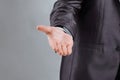 Close up. the businessman reaches out to the partner .isolated on grey background Royalty Free Stock Photo