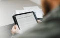 Close up businessman reading elecronic rental agreement on tablet. Royalty Free Stock Photo