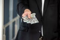 close-up of businessman& x27;s hand in branded suit holding dollar banknotes. Royalty Free Stock Photo