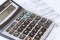 close up of a businessman\'s hand with a calculator and documents .