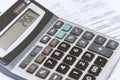 close up of a businessman\'s hand with a calculator and documents .