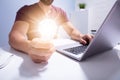 Businessman Holding Illuminated Light Bulb