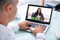 Businessman Videoconferencing With Colleague On Laptop