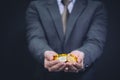 Close-up of businessman`s hands full of bitcoin sign of coins.