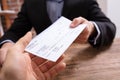 Man`s Hands Giving Cheque To Other Person Royalty Free Stock Photo