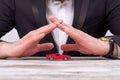 Close-up businessman's hands protecting a toy car model. Royalty Free Stock Photo