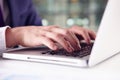 Close up of businessman?s hands using the keypad of a laptop Royalty Free Stock Photo