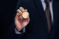 Close-up of businessman showing and holding bitcoin sign of coin - indicating crypto currency and future of digital financial bank Royalty Free Stock Photo