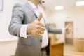 Close-up businessman showing thumbs up on the office background. Business success concept.